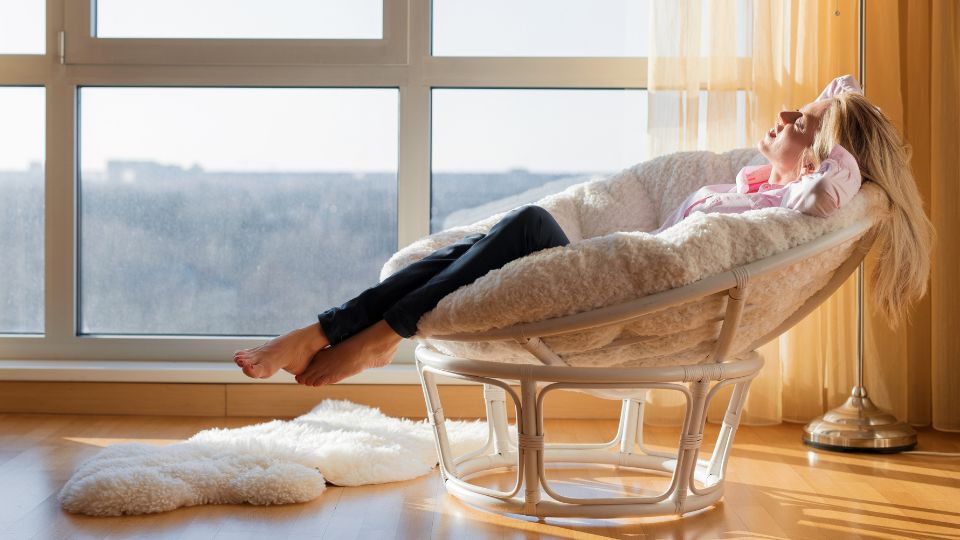Woman Relaxing in Chair By The Window